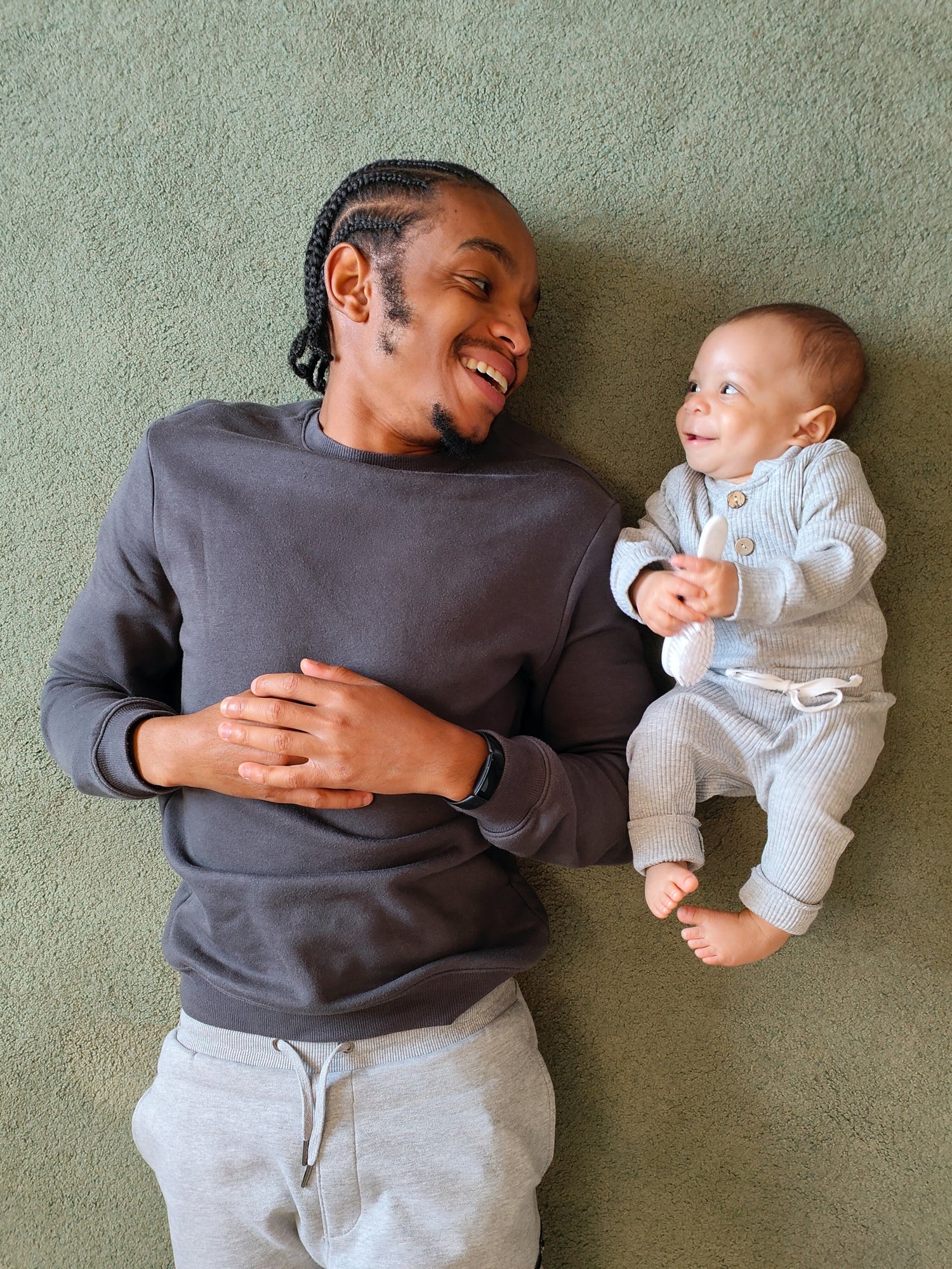 Father and baby smiling together, illustrating affordable home paternity DNA test options