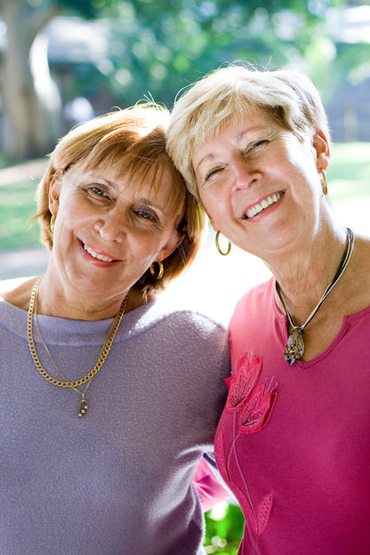 Two adult siblings smiling together, representing sibling DNA testing